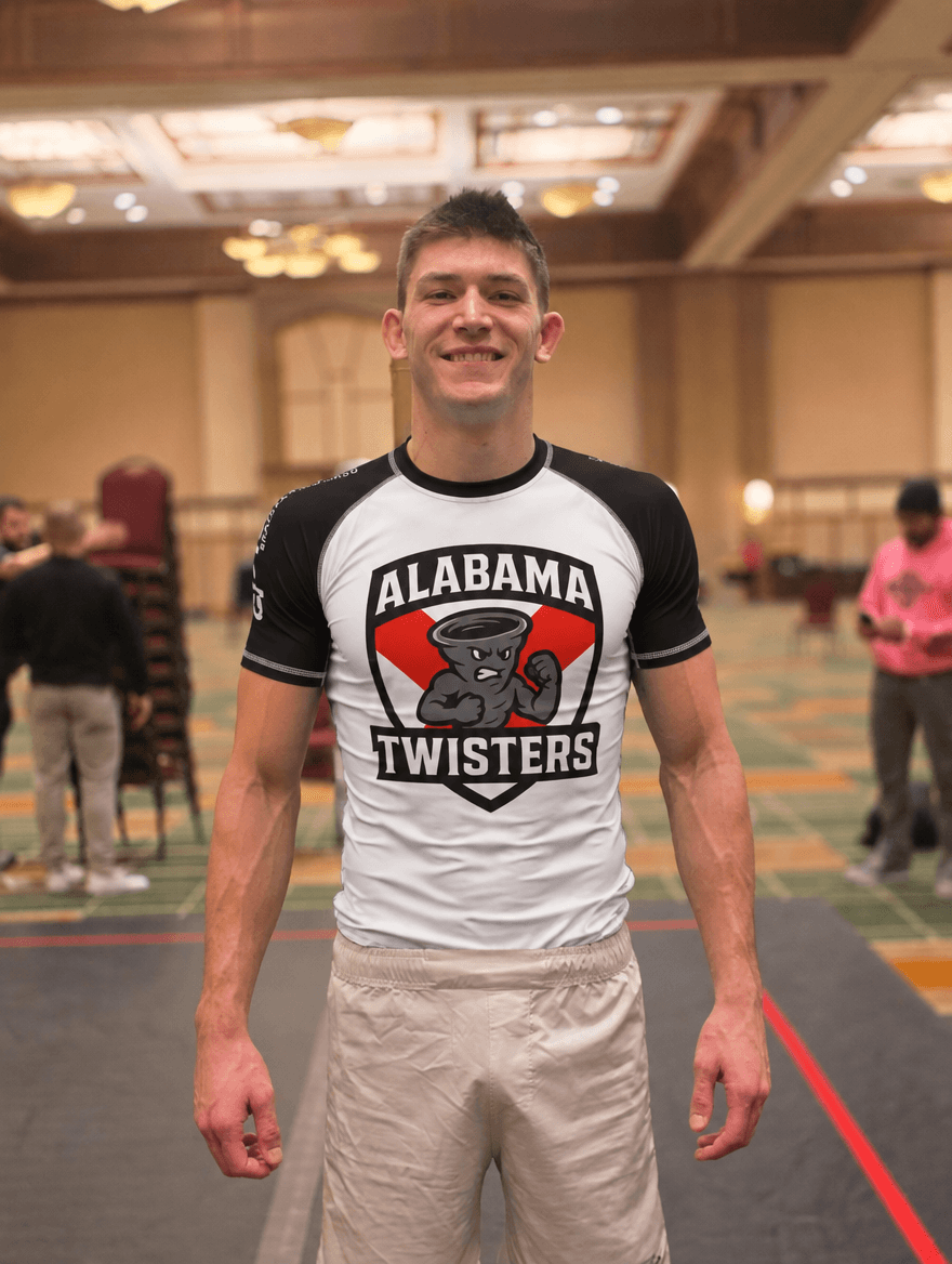 Travis Haven smiling in an Alabama Twisters rash guard.