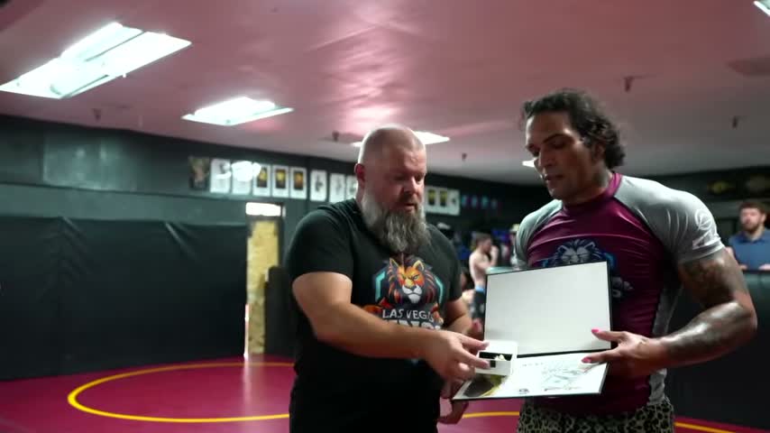 Kris Olivo receives his award after winning the 170-pound Las Vegas qualifier.
